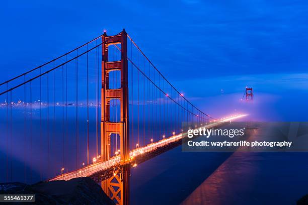 red golden gate bridge under a foggy sky - san francisco bay stock pictures, royalty-free photos & images