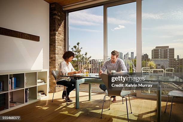 40's couple in apartment - hot works stock pictures, royalty-free photos & images