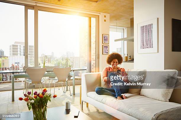 40's couple in apartment - modern cityscape stock pictures, royalty-free photos & images