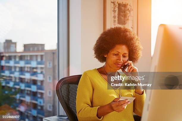 40's couple in apartment - happy consumer on phone stock pictures, royalty-free photos & images