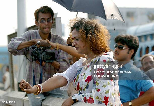 Indian transexual Manabi is watched by director Robin Das as she rehearses a scene for a film in Kolkata, 15 September 2005. The film made for...