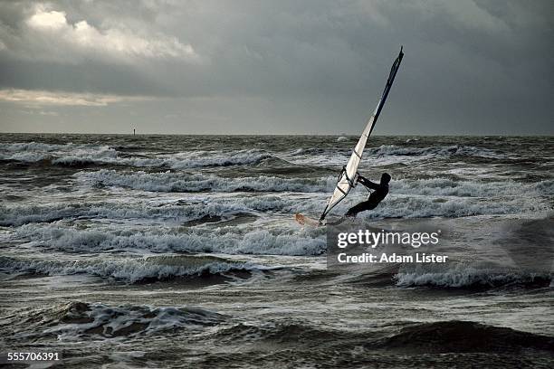 stormy windsurfing - wind surfing stock pictures, royalty-free photos & images
