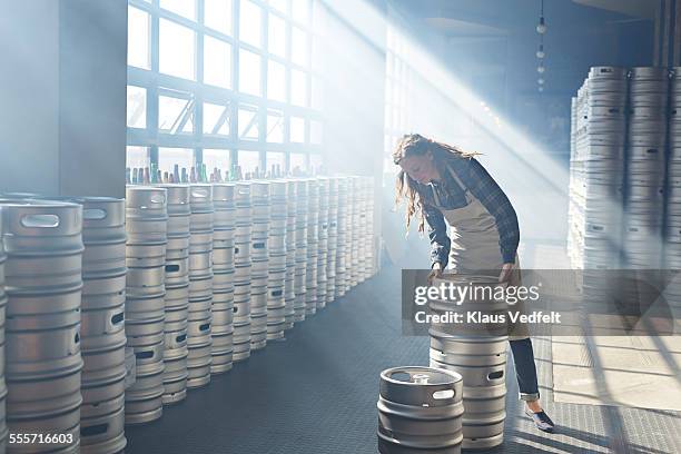 bartender sorting out beer keg's at microbrewery - microbrewery stock pictures, royalty-free photos & images