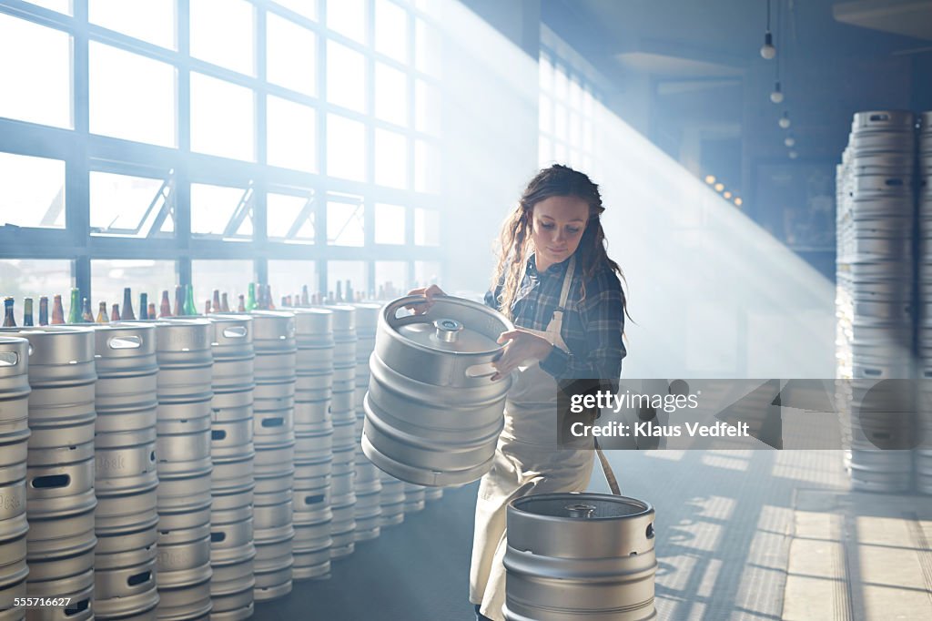 Waiter carrying beer keg's at microbrewery