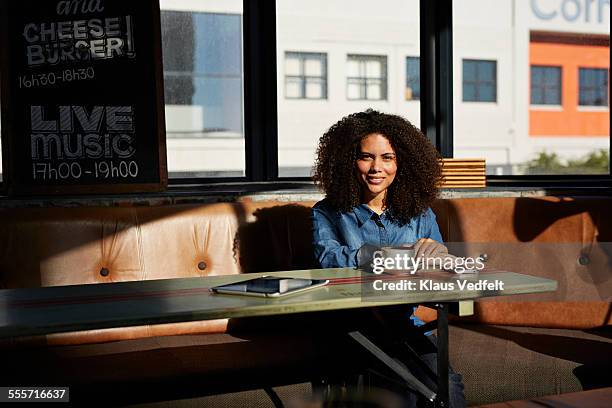 portrait of cool girl at café, with coffee & phone - sitting drinking coffee man stock-fotos und bilder