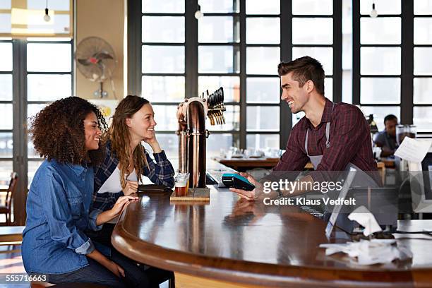 bartender doing creditcard transaction - microbrewery stock pictures, royalty-free photos & images