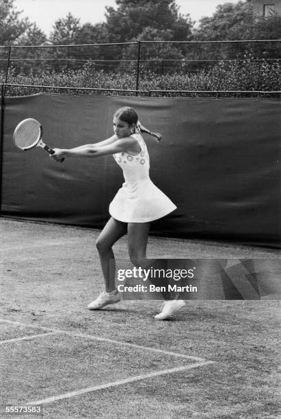 American tennis player Chris Evert swings her racquet during a match against Australian Evonne Goolagong during the Championship at Wimbledon,...