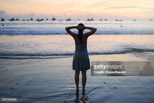 young woman enjoying sea's view at sunset - san juan del sur fotografías e imágenes de stock