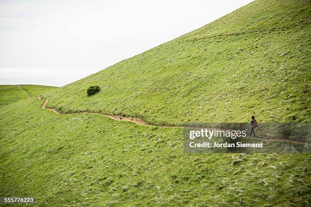 woman day hiking - hill stock-fotos und bilder