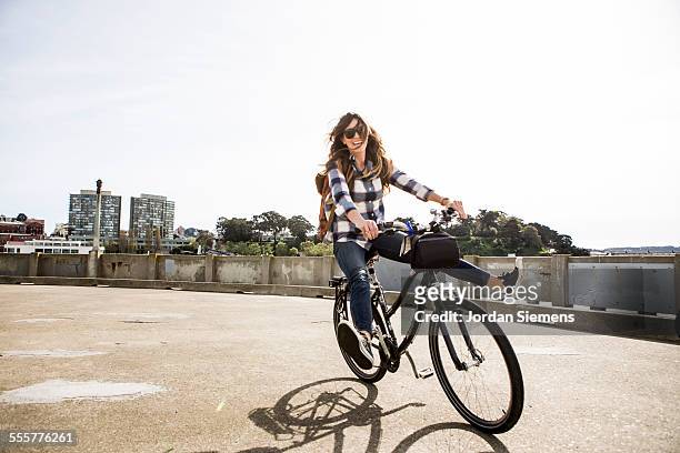 a female having fun on a bike - riding hat stock-fotos und bilder