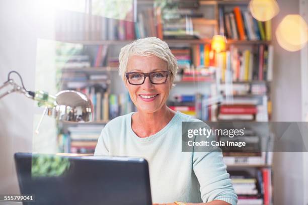 Businesswoman smiling at computer in home office