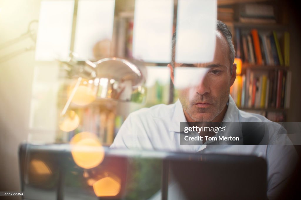 Businessman using laptop in home office