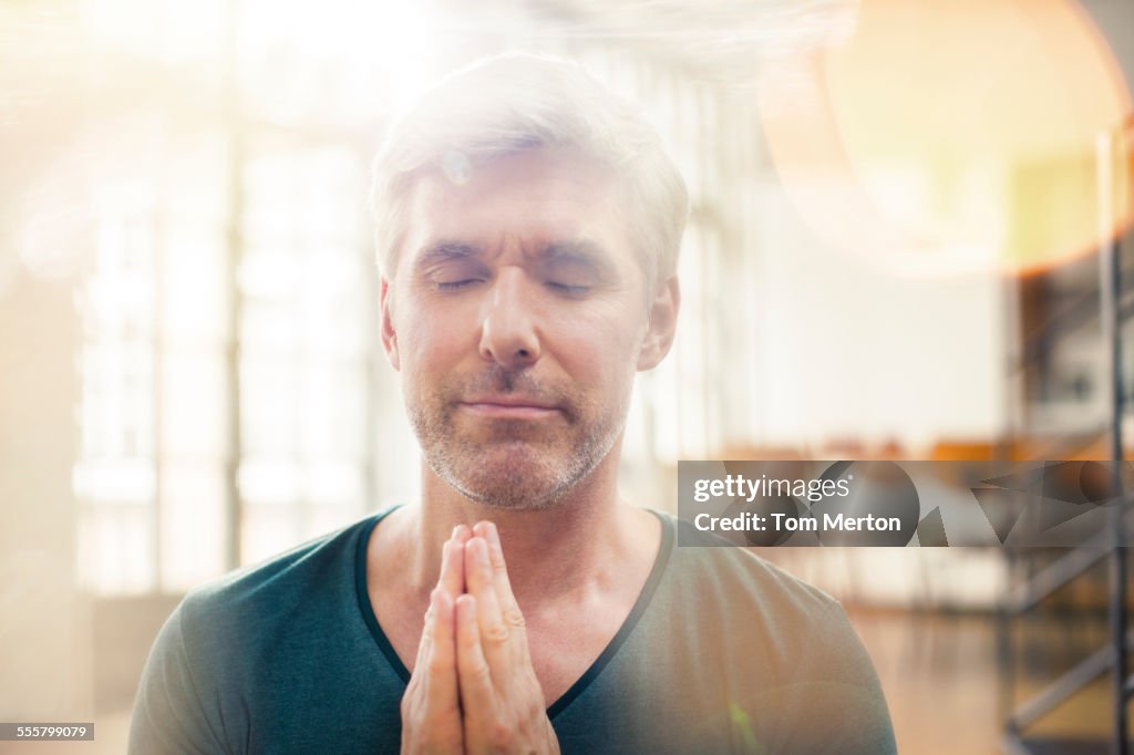 Close up of older man meditating