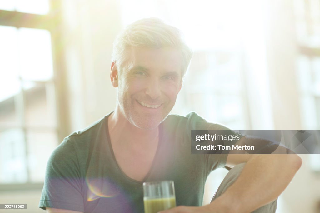 Older man drinking glass of juice