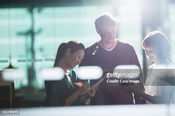 business people working late in office - soft focus office stock pictures, royalty-free photos & images