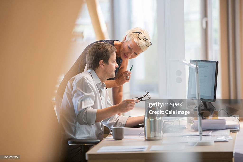 Business people talking at office desk