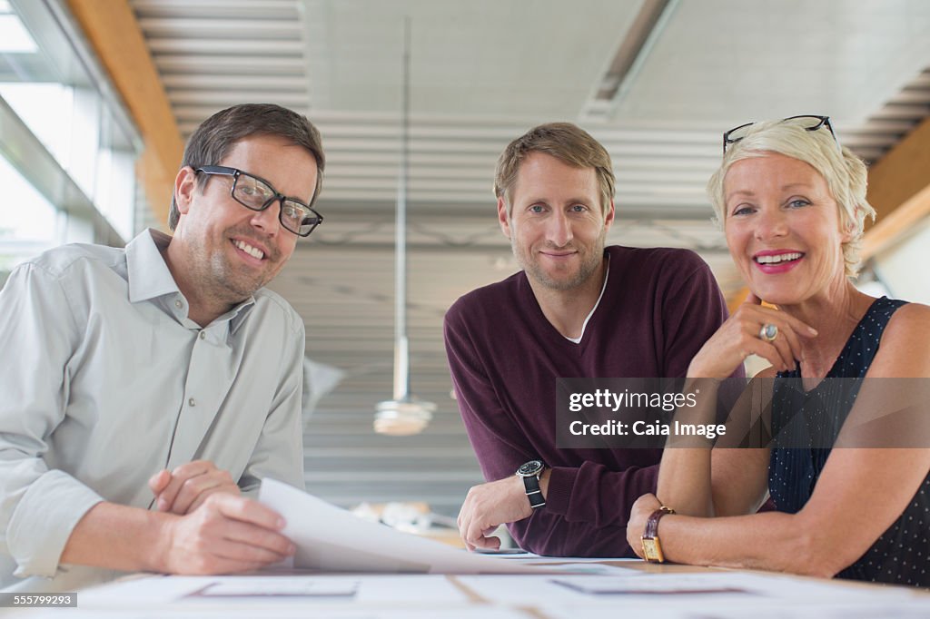 Business people smiling in office meeting