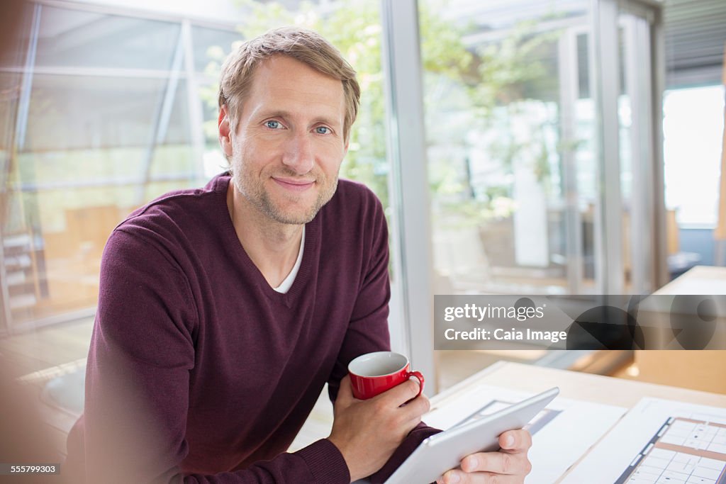 Businessman using digital tablet at office desk