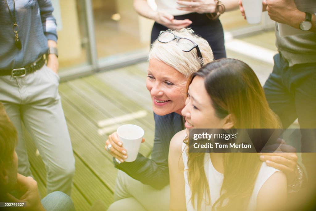 Businesswomen smiling in courtyard