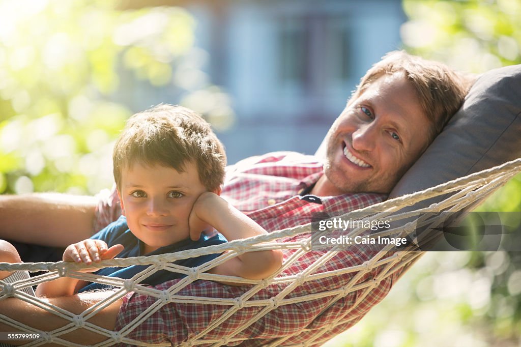 Father and son relaxing in hammock