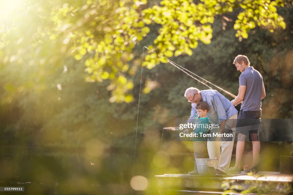 Junge, Vater und Großvater beim Angeln im See