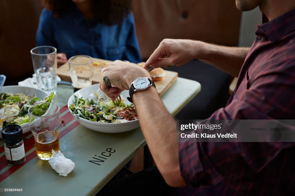 Close-up of hands at dinner in cafe