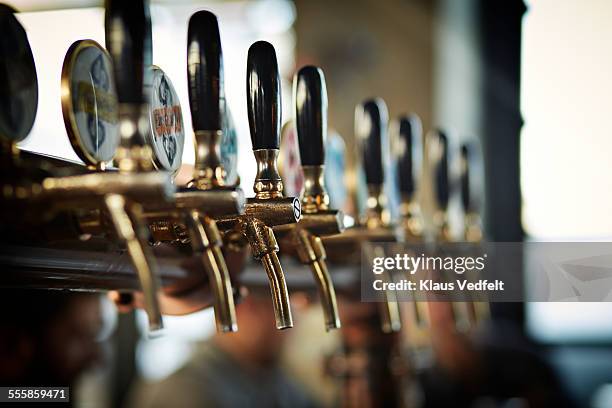 close-up of beer taps at microbrewery - bier zapfhahn stock-fotos und bilder