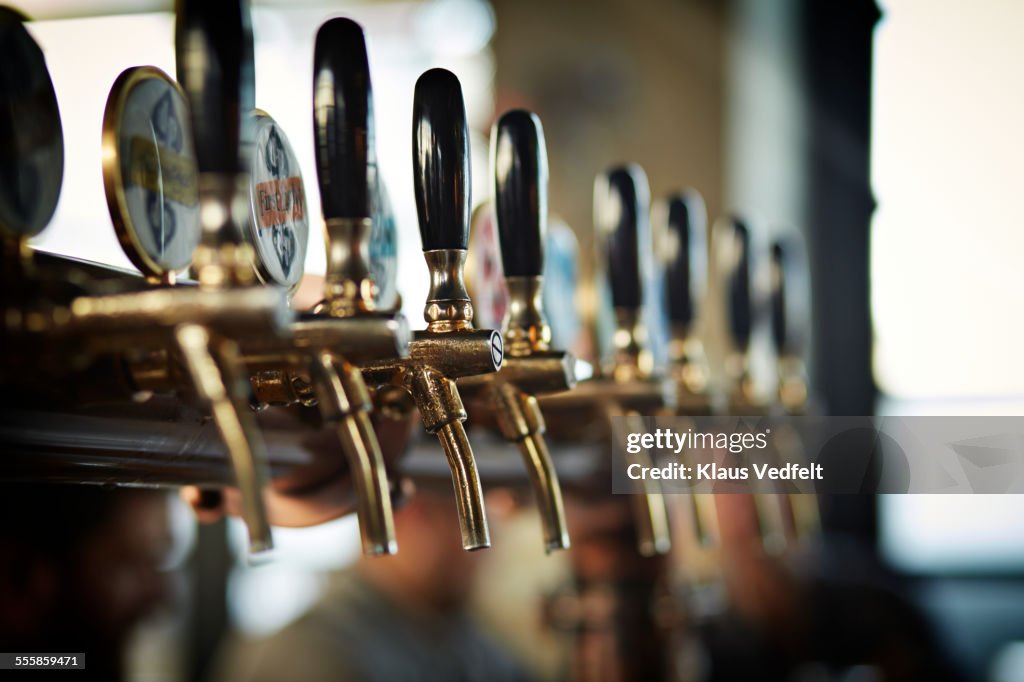 Close-up of beer taps at microbrewery