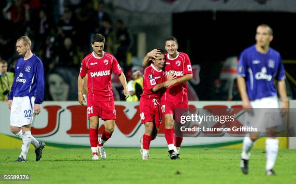 Alexandru Baltoi of Dinamo congratulates Florentin Petre on scoring the third goal in front of a dissapointed Tony Hibbert and Leon Osman of Everton...