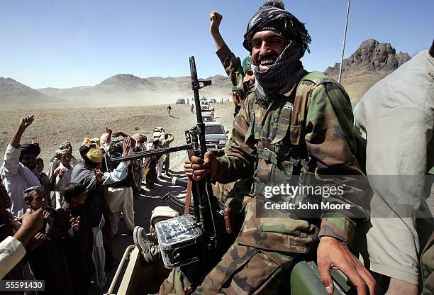 Afghan Army soldiers escorting parliamentary candidate Sayed Mahmood Gailani's campaign convoy react to the crowd September 15, 2005 in Desi,...