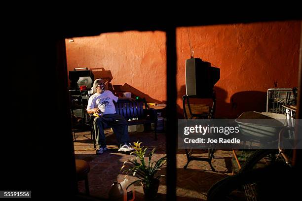 John Wade, a resident of the French Quarter, watches television powered by a generator as U.S. President George W. Bush delivers his speech to the...