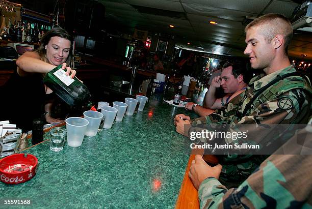 Bartender pours drinks for a group of National Guard soldiers at a bar September 15, 2005 in Gretna, Louisiana. Rescue efforts and clean up continue...