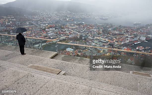 man overlooking a rainy day in bergen - bergen norway stock pictures, royalty-free photos & images