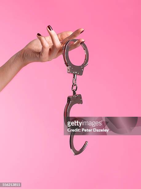 young woman into bondage - handcuffs photos et images de collection