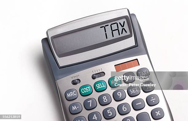 tax written on a calculator - financial responsibility stock pictures, royalty-free photos & images