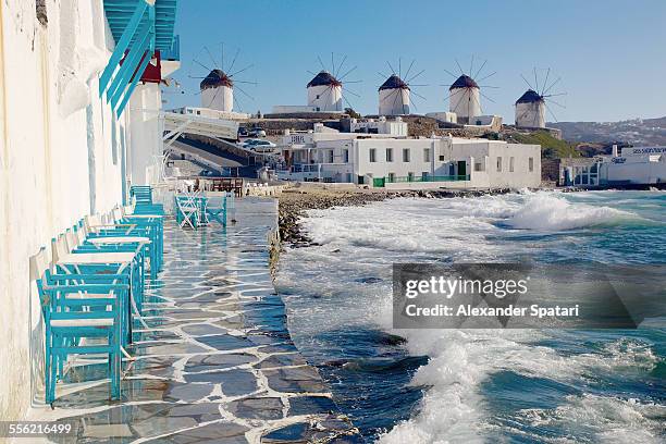 cafe and windmills in mykonos, greece - griechische inseln stock-fotos und bilder