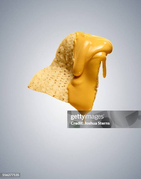 nacho cheese chip - sticky foto e immagini stock