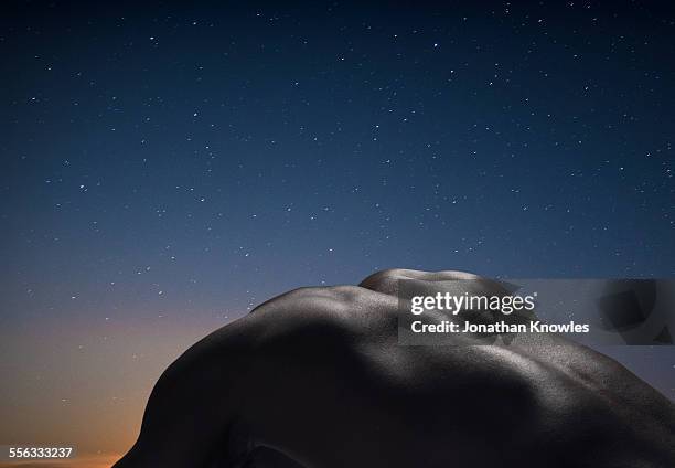 Male's back, night in the background