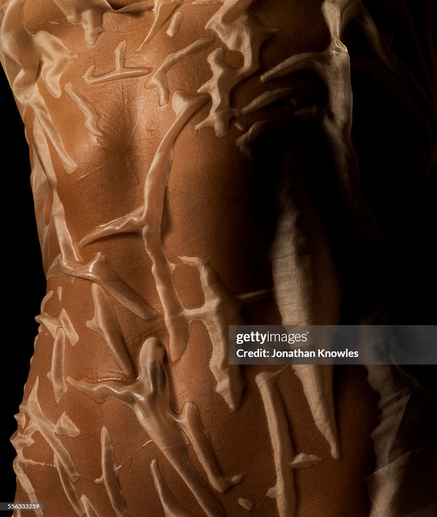 Female wet body covered in see-through textile