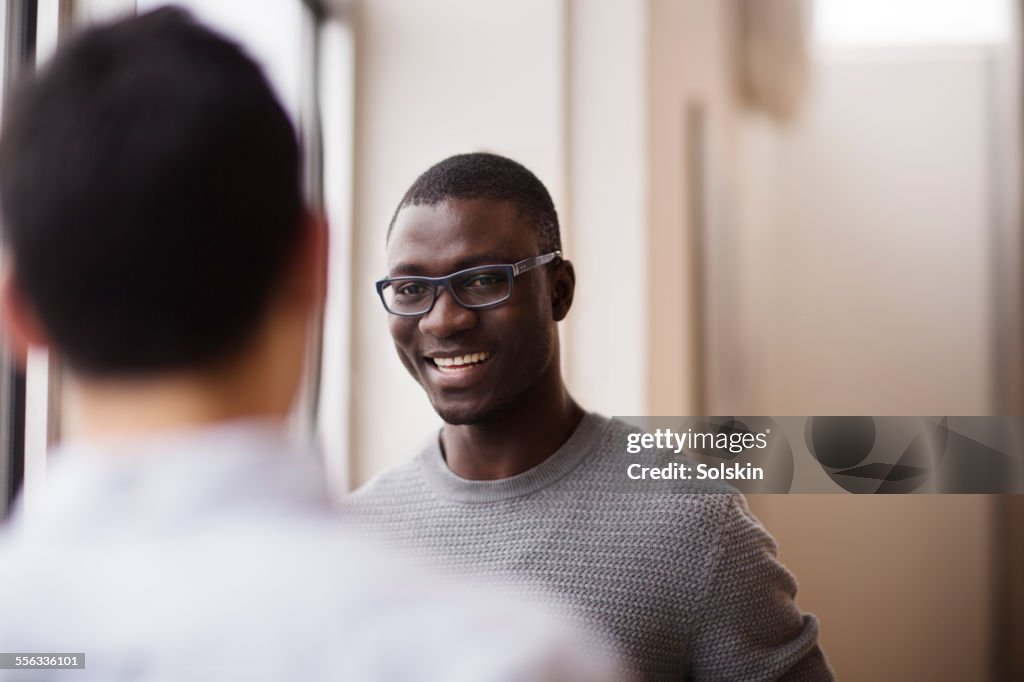 Two men in conversation in office