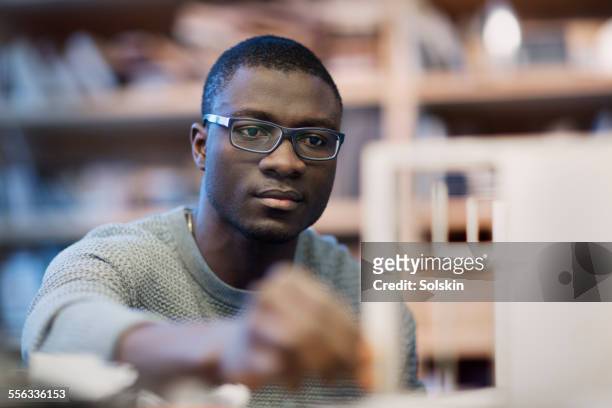 man in office looking at architecture model - high standards stock pictures, royalty-free photos & images