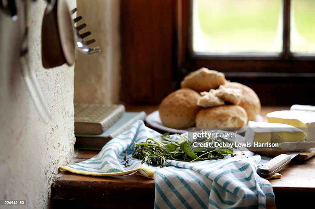 Bread rolls and brie on kitchen counter