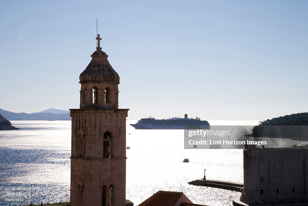 Silhouetted view of church tower and distant cruise ship, Dubrovnik, Croatia