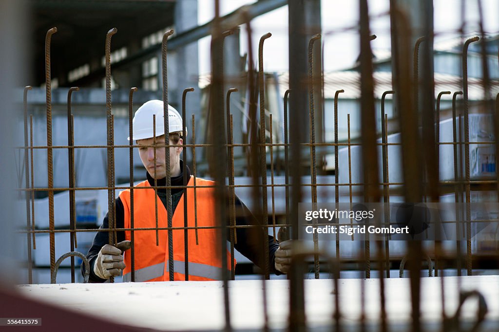 Factory worker choosing wire mesh in concrete reinforcement factory
