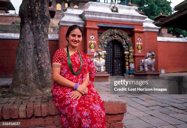 portrait of nepalese woman sitting outside temple, kathmandu, nepal - kathmandu stockfoto's en -beelden