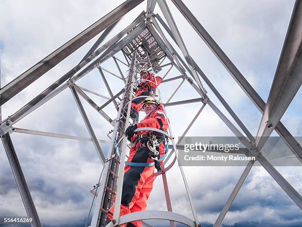 tower workers climbing radio tower on offshore windfarm, low angle view - telecommunications equipment 個照片及圖片檔