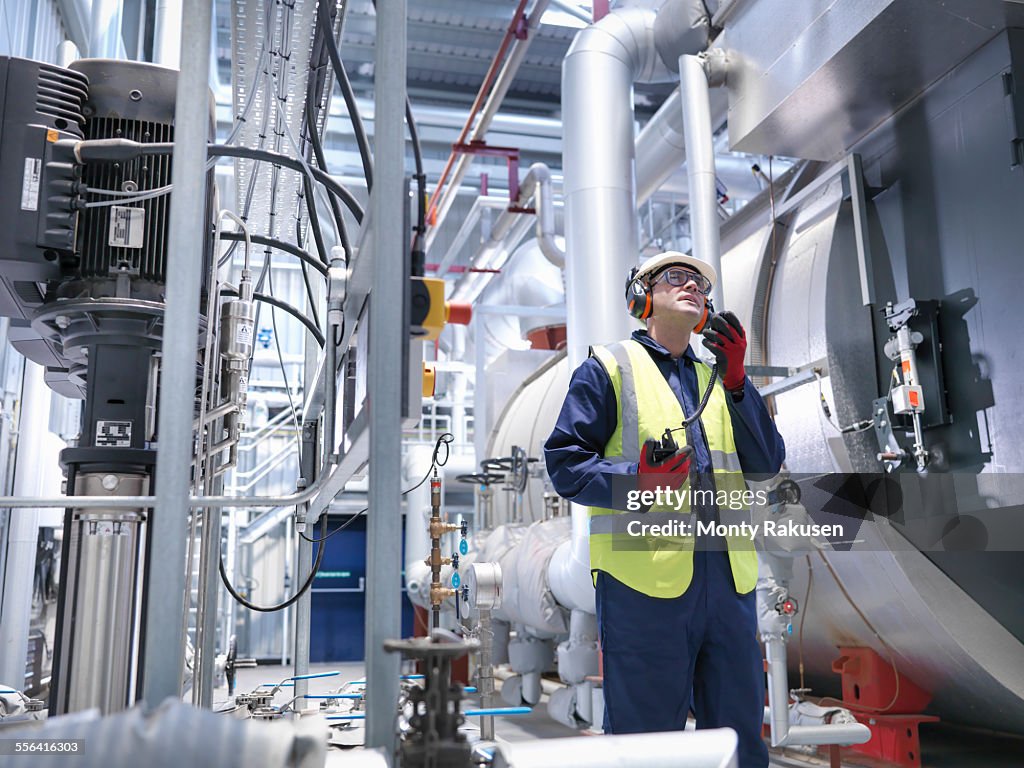 Worker using radio in gas fired power station