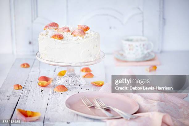 still life of cream cake on cake stand garnished with rose petals - cakestand stock-fotos und bilder