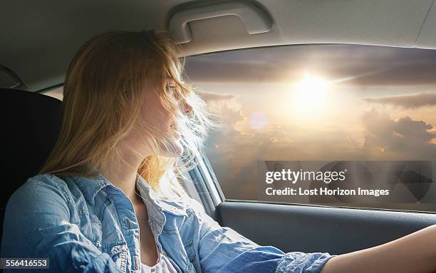 woman driving car and watching sunset - car top view photos et images de collection