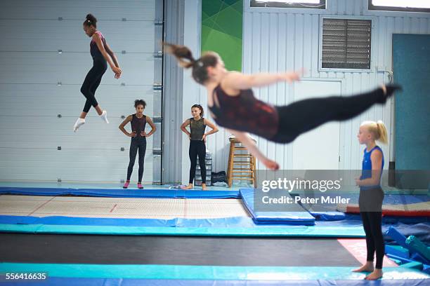 young gymnasts practising moves - acrobatic stock pictures, royalty-free photos & images